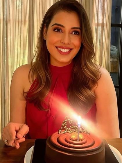 A lovely birthday celebration made sweeter with our classic chocolate cake. The single lit candle and the bright smile say it all.