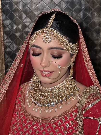 The complete bridal portrait. Her traditional matha patti and nath are balanced with a soft yet defined makeup look.