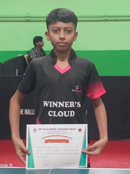 Harshith holds his certificate of merit after securing 3rd place in the Under 13 Boys singles at the Karnataka state ranking tournament.