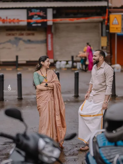 A candid shot in the middle of a street, capturing a real moment with the city life happening around them.