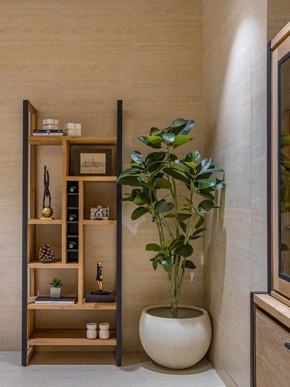 This custom shelving unit in the director's room acts as both storage and a display for curated art pieces. The combination of open and closed sections, along with the black metal frame, creates a modern, graphic element.