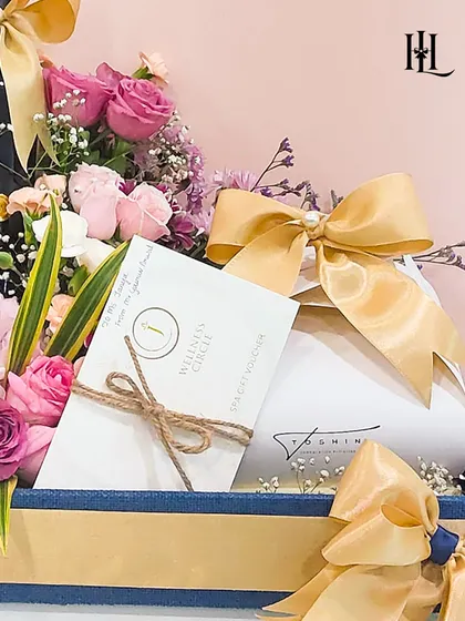 A close-up of the birthday hamper, showing the wellness spa voucher tucked inside. This demonstrates how I can incorporate experiential gifts alongside physical products for a well-rounded surprise.