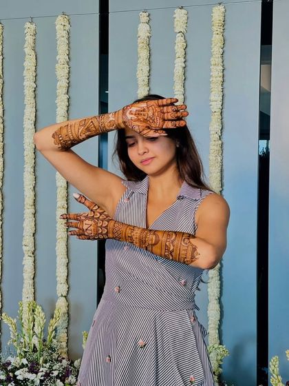 A stylish pose from the same client, highlighting the intricate patterns on her arms.