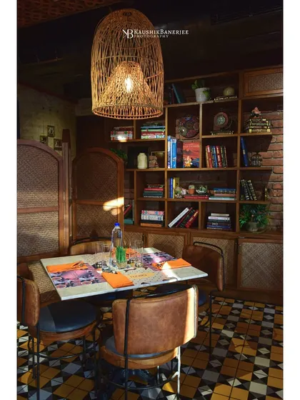 This cozy dining nook at Masia shows how lighting and texture create a warm, inviting atmosphere. I focused on the interplay between the wicker pendant lamp, the book-filled shelves, and the rustic furniture to capture the restaurant's character.