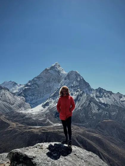 Posing on a rock with a massive mountain in the background. These moments are a reward for all the hard work and training.