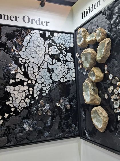 A black and white textured artwork by Maria Molaei, titled 'Inner Order', resembling natural mineral patterns.