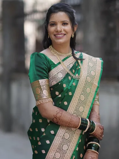 Elegance personified for an engagement ceremony. This client is glowing in a classic green silk saree, with natural-looking makeup and a simple hairstyle that highlights her happiness.