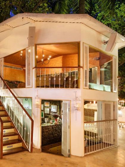 The two-story structure that houses our indoor dining rooms, viewed from the outdoor terrace at night.