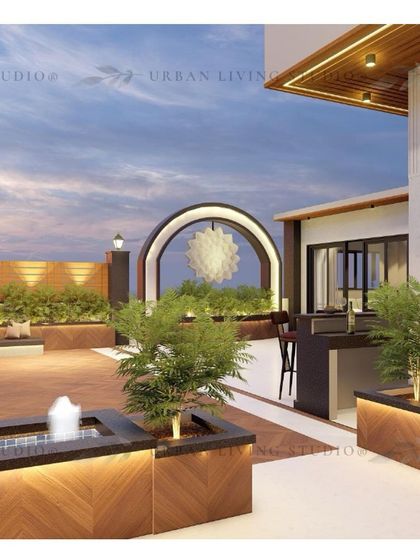 A wider view of the Gurgaon terrace design, showing the layout with a bar, a water feature, and multiple planters that create a green oasis in the sky.