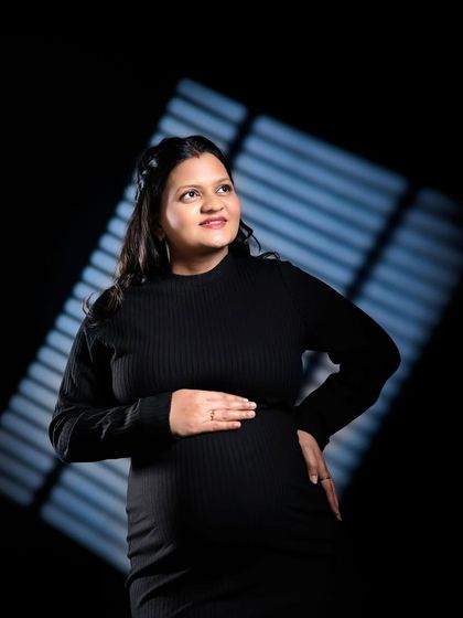 Another example of using creative lighting patterns. The diagonal light adds interest and dimension to this portrait against a dark background.