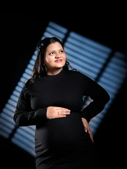 Another example of using creative lighting patterns. The diagonal light adds interest and dimension to this portrait against a dark background.