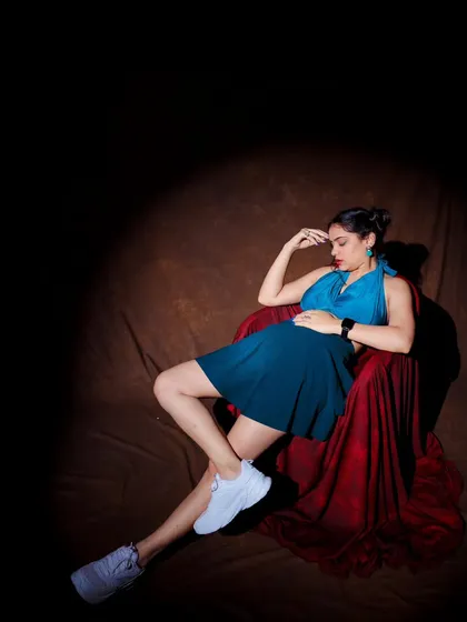 Another angle of the spotlight shot, this time with a more thoughtful pose. It shows the model's ability to convey different emotions.