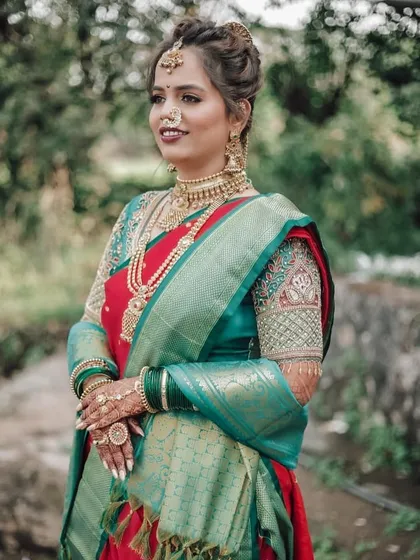 The bride Pranali looking stunning in her traditional Maharashtrian attire, with a beautiful natural backdrop.