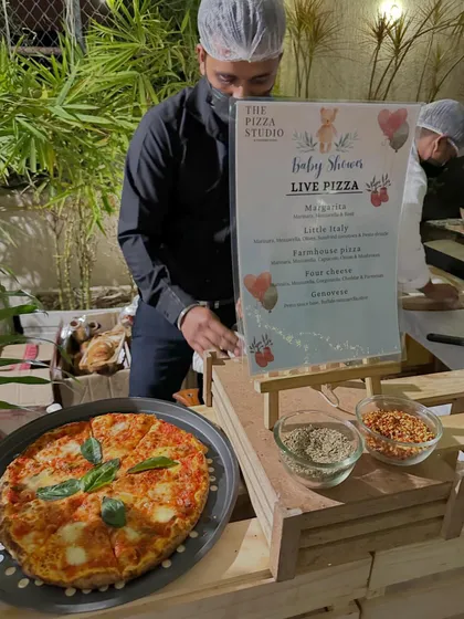 Our live pizza station is a perfect fit for any celebration, including this lovely baby shower. A freshly made Margherita pizza is on display next to our menu, ready to be served to guests.