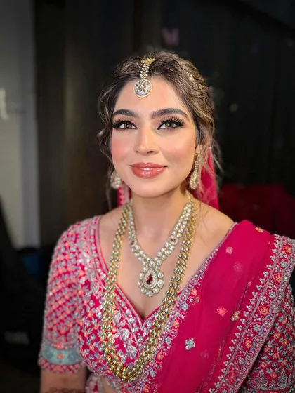 A close-up of Jasleen's bridal makeup, highlighting the flawless skin and the subtle shimmer on the eyes for a touch of glamour.