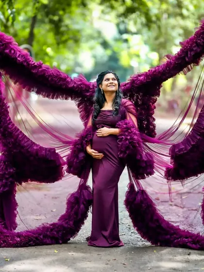 Feel like a goddess in my signature butterfly-effect maternity gown. The dramatic ruffled wings create a stunning silhouette that celebrates your journey to motherhood. This deep purple gown is a favorite for outdoor maternity shoots, adding a touch of royalty and magic.