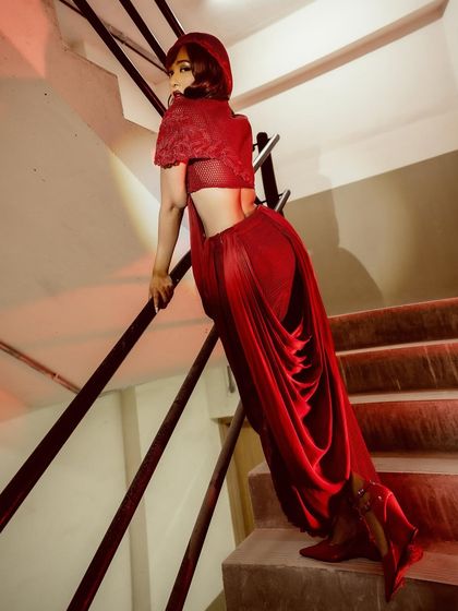 The dramatic drape of the crimson cowl-drape skirt, showcasing its effortless and elevated design.