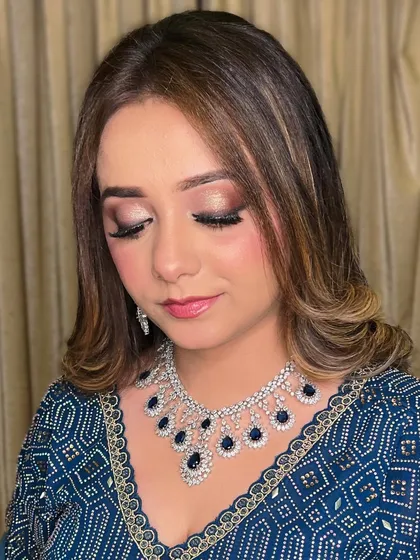 Eyes closed to show the beautiful blend of eyeshadows. The subtle shimmer adds a touch of glamour without being overwhelming.
