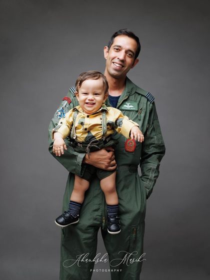 A duplicate of the joyful father and son portrait, this image continues to radiate happiness and paternal love.