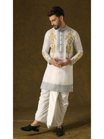 A dynamic pose in the 'Narayan Nirvana' set, showing the beautiful drape of the organza kurta and the classic appeal of the dhoti.