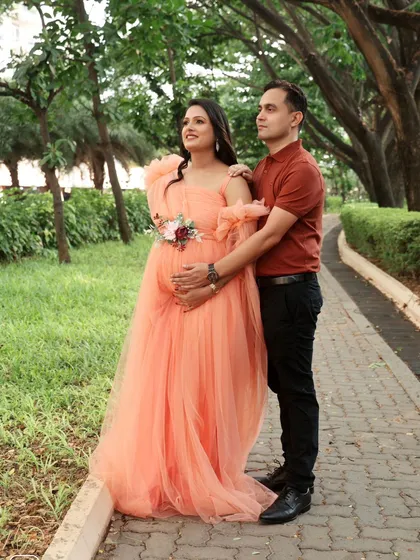 A beautiful portrait of the couple on a tree-lined path. The soft peach gown looks lovely in the natural, golden light.