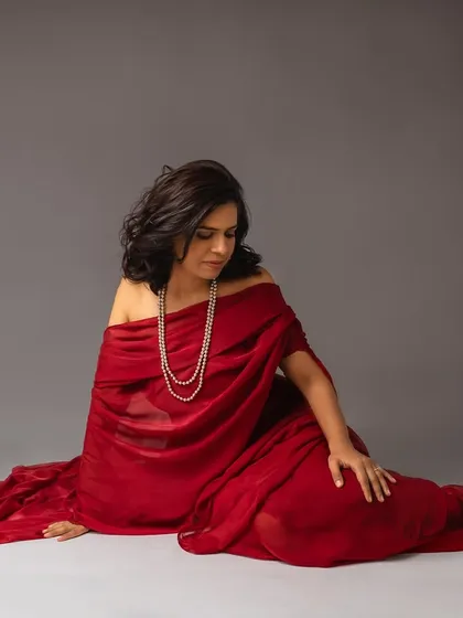 A moment to witness your own beauty. This portrait, with the red fabric draped elegantly, is a timeless and powerful image that tells a story of confidence and grace.