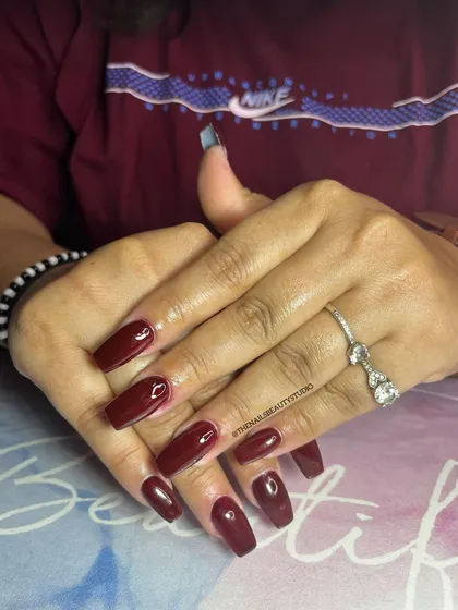 There's a shade of red for everyone. This classic, deep red on coffin-shaped nails is always a powerful choice.