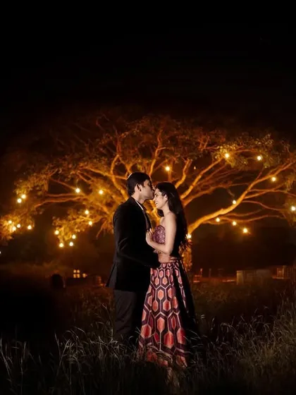 A magical night-time proposal under a beautifully lit tree. We specialize in capturing the surprise and joy of these once-in-a-lifetime moments, using creative lighting to create a truly romantic atmosphere.