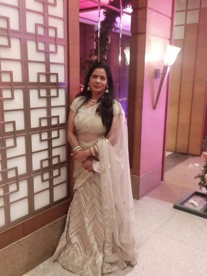 Another shot of the graceful beige and gold lehenga, a timeless choice for any occasion.