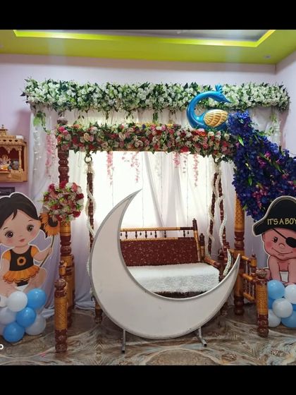 The peacock-themed baby shower setup in natural light, showcasing the vibrant colors of the flowers and props.