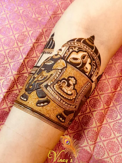 An intricate arm band design featuring a royal elephant carrying a deity in a howdah. This is a great example of a "bridal startup" or accent piece.