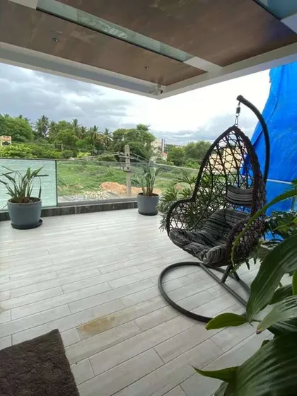 For this project in Mysore, the goal was to create a simple, elegant outdoor space. A comfortable swing chair and a few well-placed, large potted plants are enough to make this balcony a perfect spot to enjoy the view.