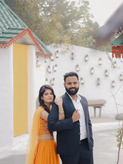 A classic portrait against a charming, village-like backdrop. Studio locations offer a variety of themes in one place, allowing for diverse looks in a single shoot.