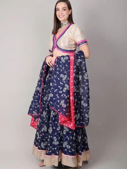 The model holds the dupatta, showing its generous length and vibrant print. Every element of the outfit is designed to add grace to your dance moves.