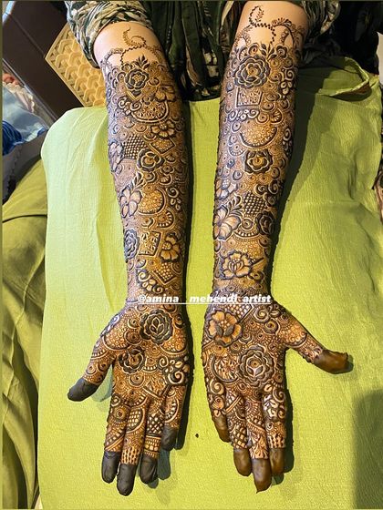 A classic top-down view of a full bridal mehendi, showcasing the symmetry and richness of the design.