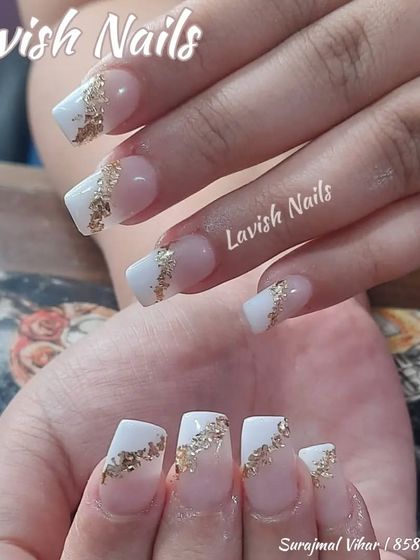 A modern take on the French manicure with white tips and a diagonal splash of gold foil.