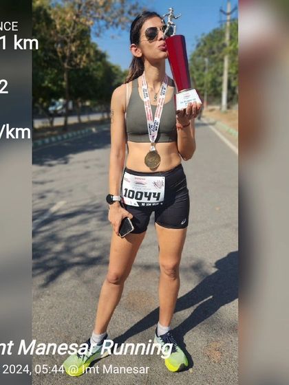Kissing the trophy after a 10.01 km race in Manesar, completed in 47:12. This podium finish is a celebration of patience, consistency, and the supportive running community that pushes me forward.