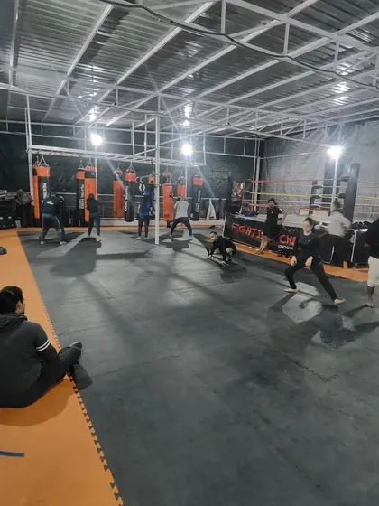 A wide shot of our Noida Extension club during a group warm-up. The facility is designed to accommodate large groups comfortably, creating a high-energy training environment.