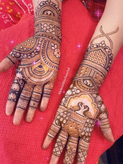 A closer look at the details. This design combines traditional peacock and lotus motifs with intricate jaal patterns and delicate finger designs for a classic yet modern bridal look.