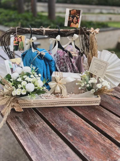The complete hanger hamper, presented on a wooden table. This image captures the full effect of the personalized photos, custom note, and beautiful styling that went into this special birthday gift.