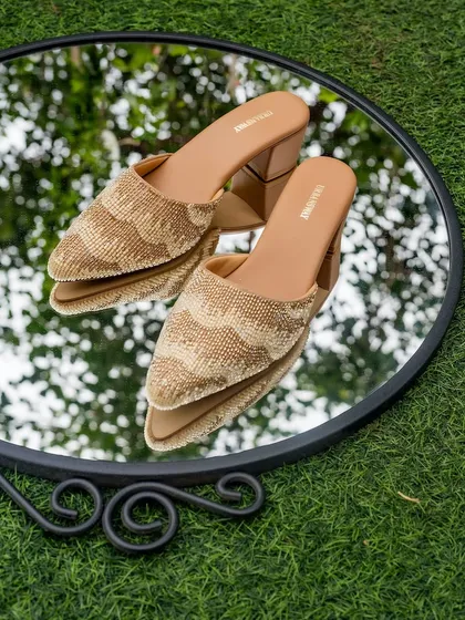 These golden beaded mules are a versatile and stylish choice. The intricate beadwork and comfortable block heel make them a go-to for any festive occasion.