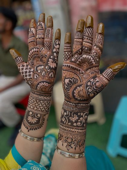 Another angle of this intricate design, showing the detailed patterns on the fingers and the beautiful floral bands on the wrist.