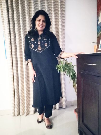 The full look of my black kurta set, paired with traditional juttis. It’s a classic, comfortable, and dignified outfit that works for many different settings.