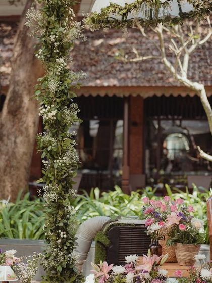 A detail shot of the delicate floral arch, made with fresh greenery and baby's breath, adding a touch of whimsical elegance to the stage.