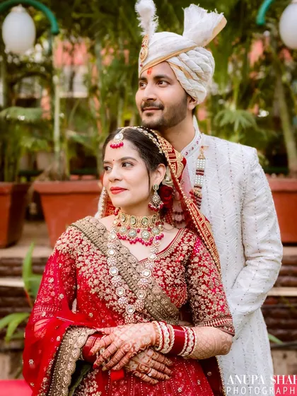 A thoughtful, composed portrait of the couple. The bride looks ahead while the groom stands behind her, creating a sense of shared dreams and a future together.