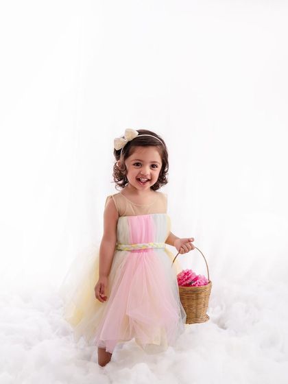 Walking on a cloud, this little flower girl is the picture of happiness in her beautiful pastel dress.