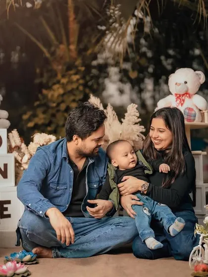 Candid moments between parents and their one-year-old are just as important as the solo shots. The shared smiles here show the love and joy of their family.