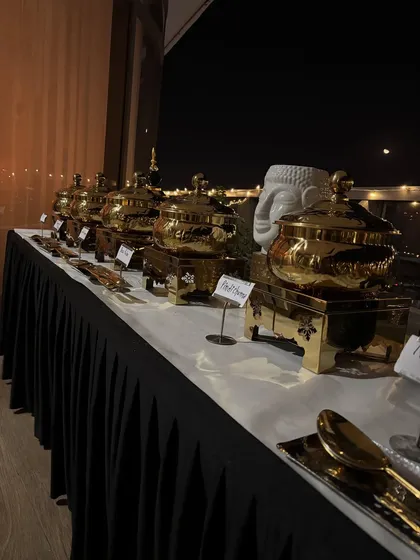 A side view of the buffet, showing the food labels for dishes like 'Dal Makhani' and 'Paneer Lababdar'.