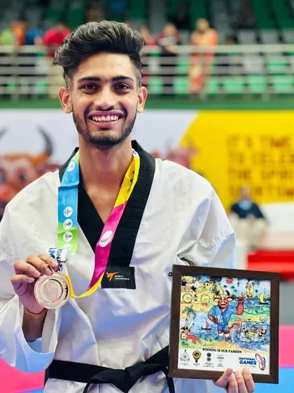 A close-up of a champion. Deepanshu proudly displaying his Bronze medal from the National Games 2023.