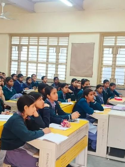 An attentive classroom of girls during a health and wellness session. I focus on topics particularly relevant to them, empowering them with knowledge about their own bodies.